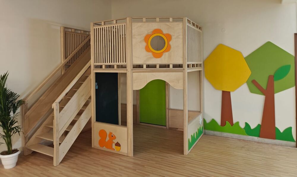 Wooden play loft with stairs and a slide