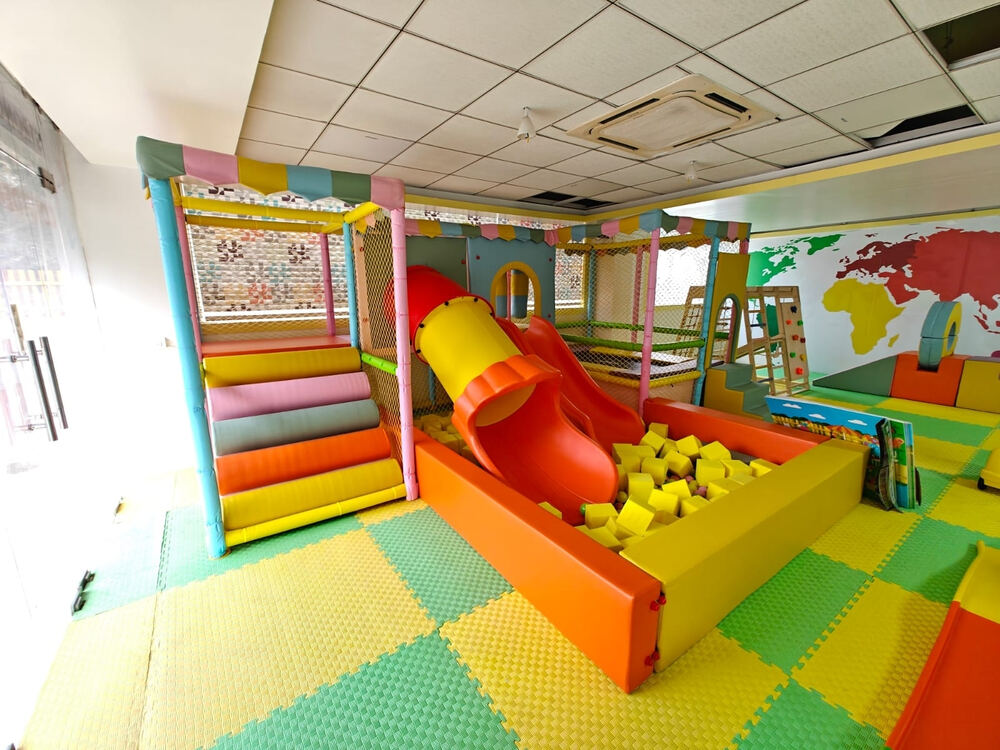 Indoor soft play area with a ball pit and slide